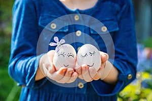 The child holds Easter eggs in his hands. Selective focus.