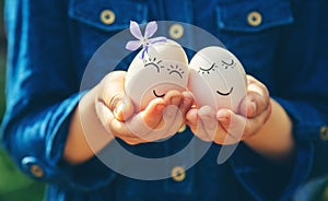 The child holds Easter eggs in his hands. Selective focus.