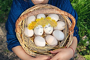 The child holds Easter eggs in his hands. Selective focus.