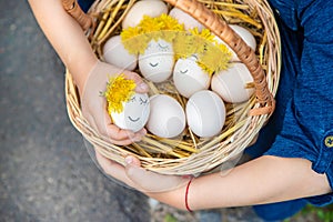 The child holds Easter eggs in his hands. Selective focus.