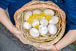 The child holds Easter eggs in his hands. Selective focus.