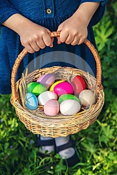 The child holds Easter eggs in his hands. Selective focus.