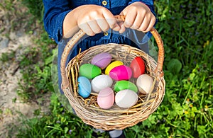 The child holds Easter eggs in his hands. Selective focus.