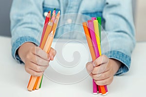A child holds a felt pens and pencils. School concept