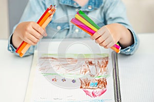A child holds a felt pens and pencils. School concept