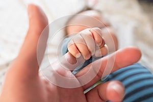 Child holds finger Mother holds the hand of her child. Mothers Day. father`s day