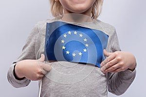 Child holds flag of European Union. Close up. Traveling with children abroad. Education abroad