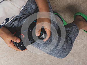 Child holds a Nintendo Wii Switch controller.