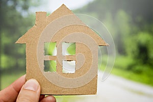 Child holds paper house. Loan for new house theme. Financial operations.