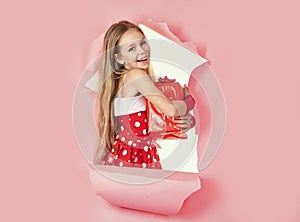 Child holidays, presents, childhood and people concept. Smiling little teen girl with gift box.