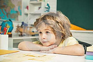 Child home studying and home education. School kids against green chalkboard.