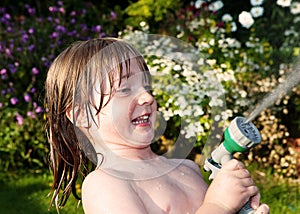 Child hosepipe water summer garden splash