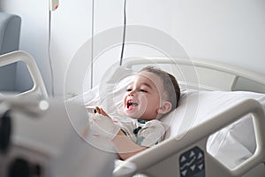 child in hospital lying in bed