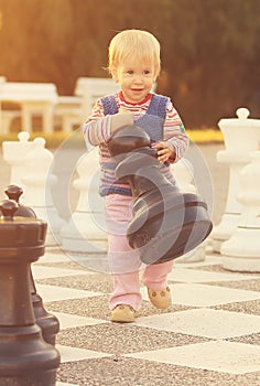 Child with huge chess figures