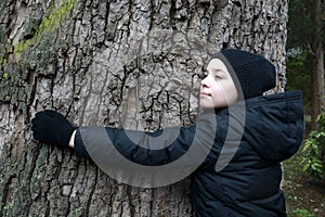 Child hugging cypress tree in Gurzuf park