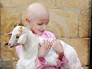 Child hugging goat