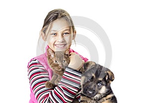 Child hugging a kitten and puppy