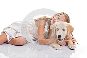 Child hugging pet puppy dog