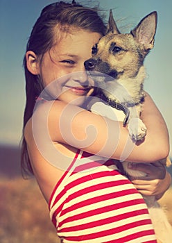 Child hugging a puppy