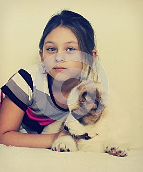 Child hugging a puppy