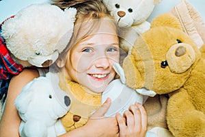 Child hugging teddy bear. Kid funny face near toys. Toys dream. Kid girl dreams near tiys teddy. Childhood dream