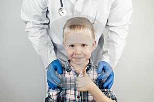 The child hugs the doctor. Examination of the boy by a pediatrician. Child protection, healthcare and medical care concept. Close-