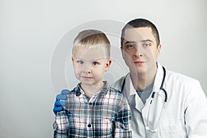 The child hugs the doctor. Examination of the boy by a pediatrician. Child protection, healthcare and medical care concept. Close-