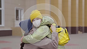 child hugs mother, mother escorts her daughter to school lesson, funny learning activities for pleasure, little kid with