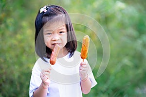 Child are hungry. Kid happily ate sausage skewers. Copy space