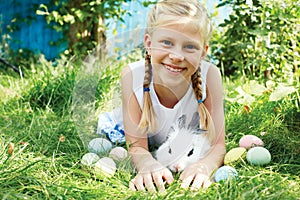 Child hunted on Easter egg in blooming spring garden.