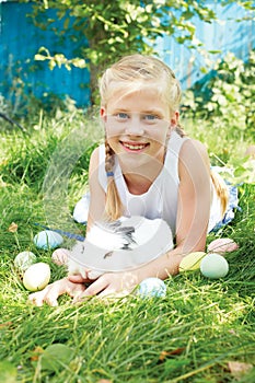 Child hunted on Easter egg in blooming spring garden.