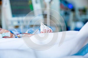 Child infant in intensive care unit. Shallow depth of field in profile with blurred background.