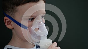 Child inhale using a nebulizer. Little boy in a nebulizer mask