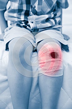 Child injured. Wound on child`s knee with bandage. Human health