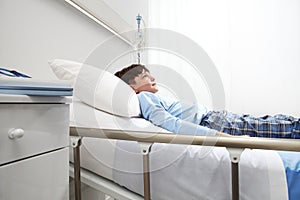 Child isolated in hospital room lying on bed wearing a pajama
