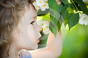 Child with jasmin flower photo