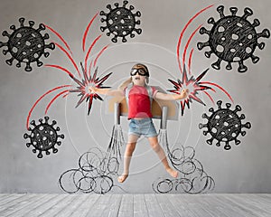 Child with jetpack jumping against drawing coronavirus