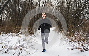 child jogging on a snowy forest in winter