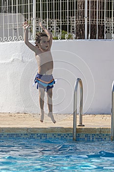 Child Joyfully Jumping into Pool Water