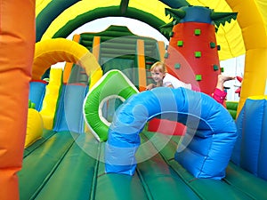 Child jumping in bouncy castle photo