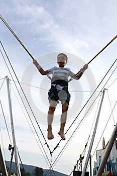 Child jumping on bungee trampoline