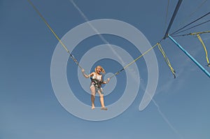 Child jumping in the jumping attraction