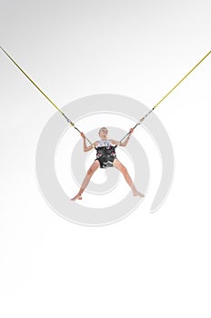 Child jumping in the jumping attraction isolated