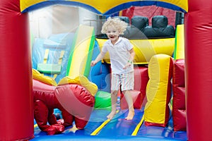 Child jumping on playground trampoline. Kids jump.