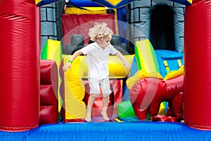 Child jumping on playground trampoline. Kids jump.