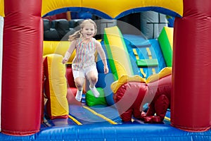 Child jumping on playground trampoline. Kids jump.