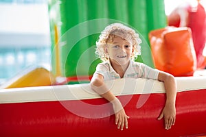 Child jumping on playground trampoline. Kids jump