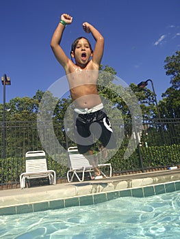 Child jumping in swimming pool