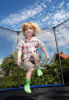 Child jumping trampoline