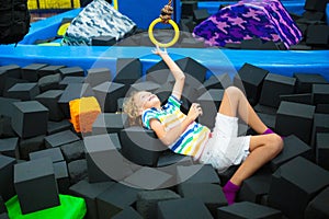 Child jumping in trampoline park. Bounce fun